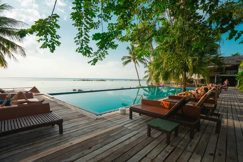 Deluxe Room interior with king bed and sea view balcony